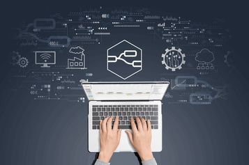 Image of hands typing on laptop working on Node-RED flows